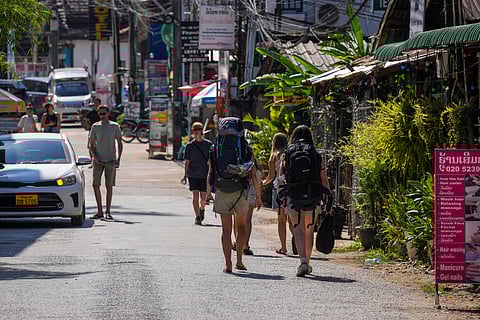 Backpacker foreign tourists roam around in Vang Vieng, Laos, Friday, Nov. 22, 2024. 