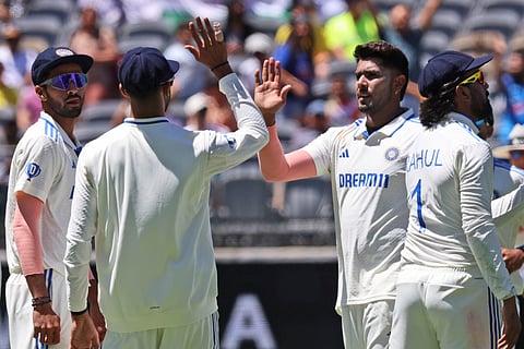 India's Harshit Rana, second right, celebrates with teammates the wicket of Australia's Nathan Lyon on the second day of the first cricket test between Australia and India in Perth, Australia, Saturday, Nov. 23, 2024.