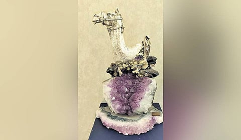 A silver clutch, marble inlay work table, silver candle stand and hand-carved silver chess set 