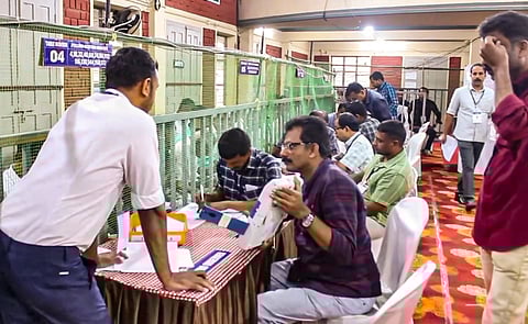 Polling officials at a counting center amid the counting of votes for the Wayanad Lok Sabha by-election, in Wayanad, Saturday, Nov. 23, 2024.