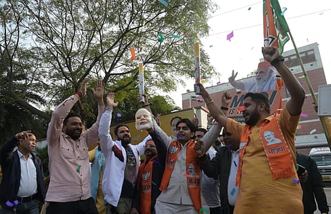 BJP workers celebrate after party wins Maharashtra elections at BJP HQ in New Delhi on Saturday.  