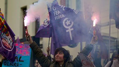 A woman holds a torch during a rally in Istanbul