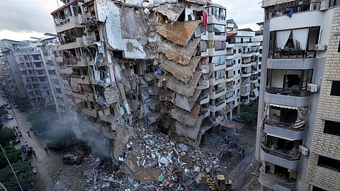 Bulldozers remove the rubble of a destroyed building that was hit Sunday night in an Israeli airstrike in Dahiyeh, in the southern suburb of Beirut, Lebanon.