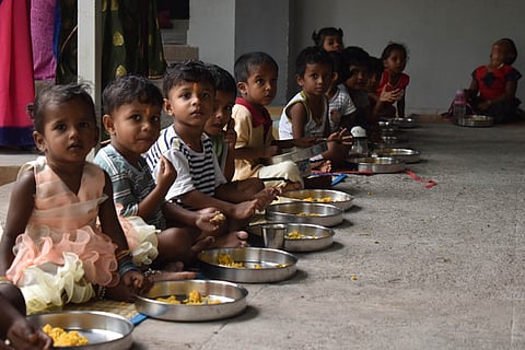 Image of children having food in anganwadi centre used for representational purpose.