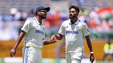 India's captain Jasprit Bumrah, left, speaks with teammate Mohammed Siraj as the latter prepares to bowl on the fourth day of the first cricket test between Australia and India in Perth, Australia, Monday, Nov. 25, 2024.