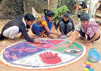 Girls making rangoli on the issue