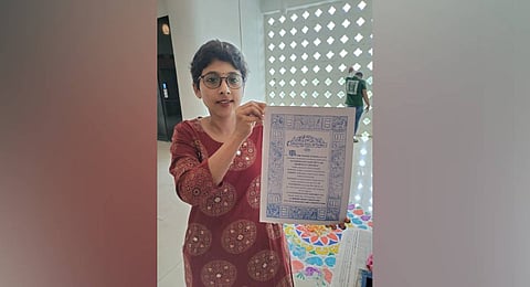 Dr Anvita, displaying the printed Constitution Preamble.
