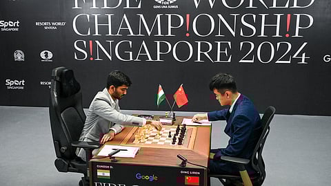 China’s chess grandmaster Ding Liren (R) and India’s chess grandmaster Gukesh Dommaraju (L) compete during the start of the FIDE World Chess Championship in Singapore on November 25, 2024.
