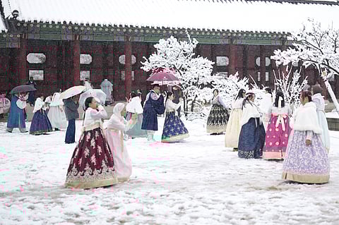 Visitors enjoy in snow at the Gyeongbok Palace, one of South Korea's well-known landmarks, in Seoul