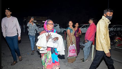 A woman rushes a baby to the emergency ward after a fire broke out in a neonatal intensive care unit at a hospital in Jhansi, India, on November 15, 2024