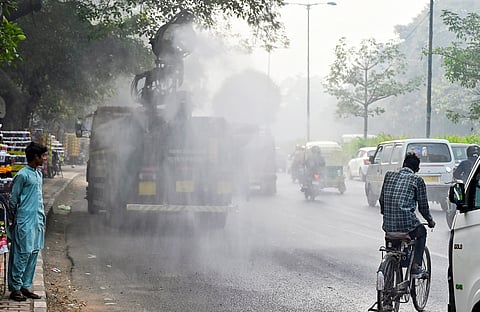 An anti-smog gun on a multi-purpose vehicle sprays water droplets to curb air pollution amid deteriorating air quality in New Delhi.