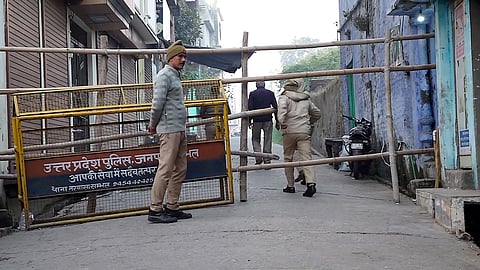 Police personnel stand guard at a barricaded street in Sambhal, Uttar Pradesh, Wednesday, Nov. 27, 2024.