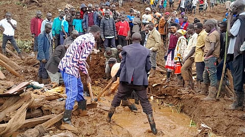 Rescue workers and people search for bodies after landslides following heavy rains buried 40 homes in the mountainous district of Bulambuli, eastern Uganda.