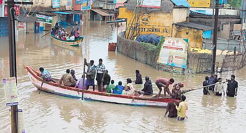 Fishermen move a boat away from the sea amidst an advisory issued by the India Meteorological Department (IMD) not to venture into the sea as a Cyclone Fengal approches. 