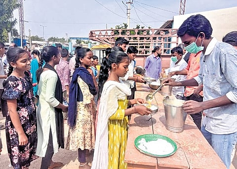 Students queue for mid-day meal at Maganoor Zilla Parishad High School in Narayanpet district
