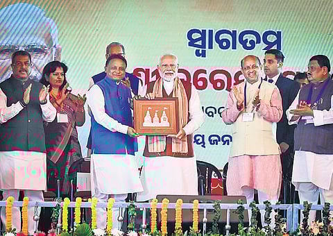 CM Mohan Charan Majhi presenting a memento to PM Narendra Modi on Friday