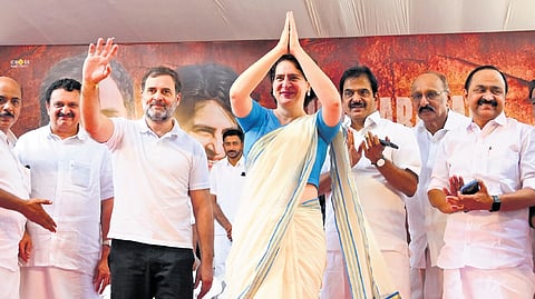 Priyanka and Rahul Gandhi greet the audience during the public meeting in Mukkam on Saturday.