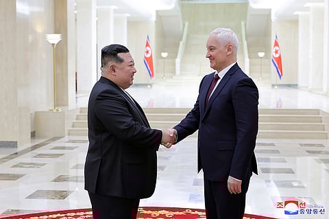 North Korean leader Kim Jong Un, left, shakes hands with Russian Defense Minister Andrei Belousov in Pyongyang, North Korea Friday,