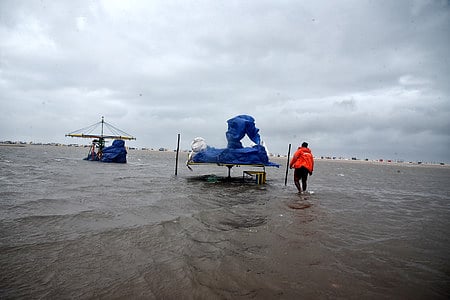 A person checks his shop at Marina ahead of  Cyclone Fengal, in Chennai