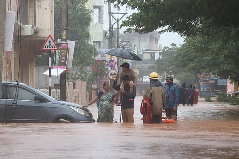 People wade through a flooded street in the aftermath of Cyclone Fengal, in Puducherry, Sunday, Dec. 1, 2024.