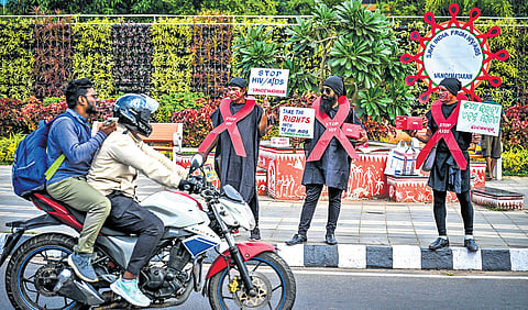 Activists conduct an awareness campaign on the occasion of AIDS Day at Master Canteen Square in Bhubaneswar on Sunday.