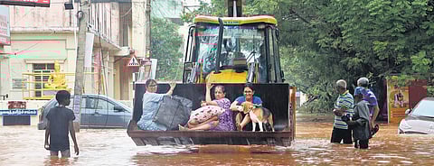 The National Disaster Response Force engaged in rescue operations using an earthmover in Puducherry on Sunday 