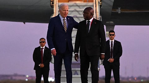 US President Joe Biden walks on the red carpet next to Angola Foreign Affairs Minister Tete Antonio upon his arrival at the Quatro de Fevereiro Luanda International Airport in Luanda on December 2, 2024. 