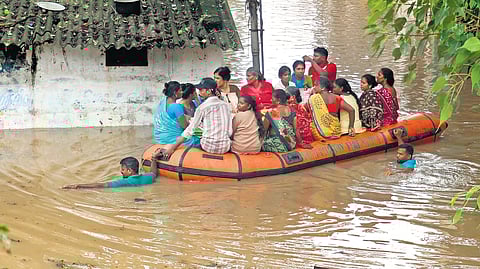 Residents being evacuated from the flooded Kanuvapettai in Puducherry on Monday 