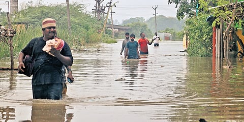 People moving to safety after their houses got flooded in Chinnakanganamkuppam in Cuddalore on Monday 