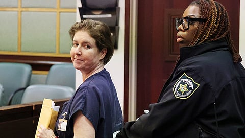 Sarah Boone smiles as she is led off in handcuffs in a courtroom of the Orange County Courthouse in Orlando, Florida, on Monday, Dec. 2, 2024.