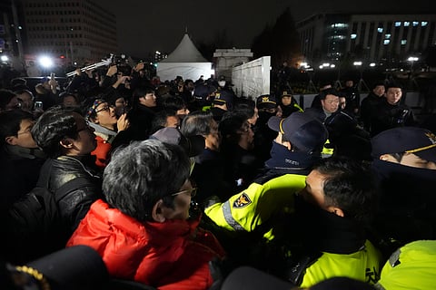People try to enter as police officers stand guard in front of the National Assembly in Seoul, South Korea,