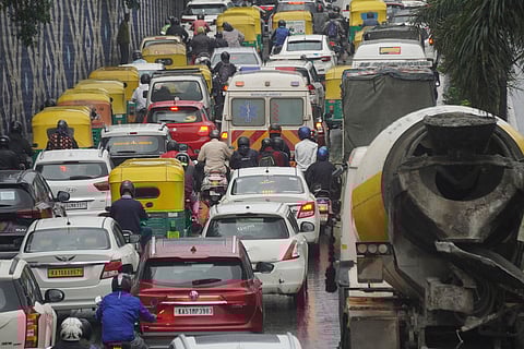 An ambulance got stuck in the heavy traffic during the rain at Guttahalli main in Bengaluru. 
