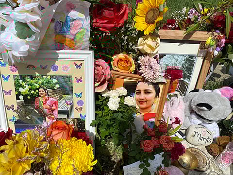 Flowers, candles and photos are placed near Mamta Kafle Bhatt's mailbox in Manassas Park, Va., Sept. 4, 2024