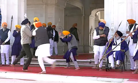 People catch a man who allegedly opened fire at Shiromani Akali Dal leader Sukhbir Singh Badal while the latter was serving the 'tankhah' (religious punishment) given by the Akal Takht at the Golden Temple, in Amritsar, Wednesday, Dec. 4, 2024.