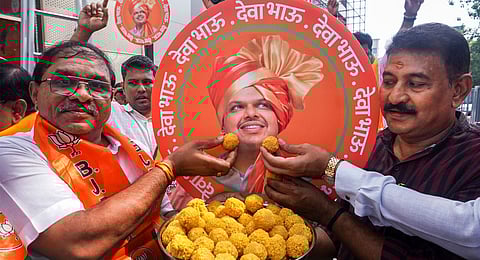 Supporters celebrate with sweets after Devendra Fadnavis was unanimously elected as BJP legislative party leader, paving the way for him to be sworn in as Maharashtra Chief Minister, in Thane, Mumbai, Wednesday, Dec. 4, 2024. 