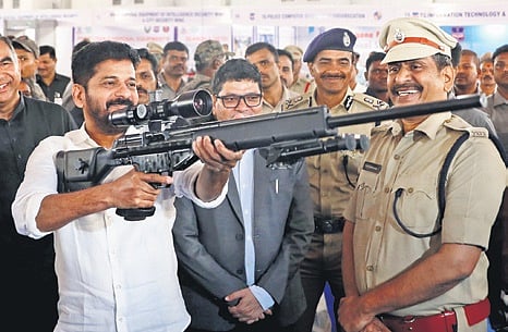 Chief Minister A Revanth Reddy checks a gun during a visit to the Police Expo organised at the HMDA Grounds in Hyderabad on Friday | Sri Loganathan Velmurugan