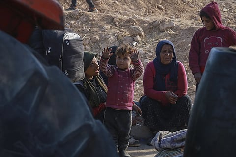Internally displaced people sit in a camp in Tabqa city, Raqqa governorate, northern Syria, on Wednesday, Dec 4, 2024.