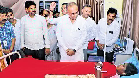 Health Minister Dinesh Gundu Rao interacts with a patient at BIMS Hospital in Ballari on Saturday