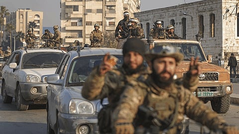 Syrian opposition fighters take to the streets in the aftermath of the opposition's takeover of Hama, Syria, Friday, Dec. 6, 2024. 