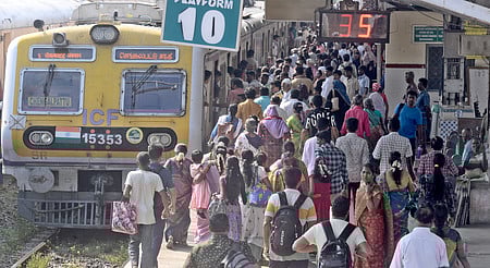 Passengers seen thronged on platforms to board local trains at Egmore railway station in Chennai. 