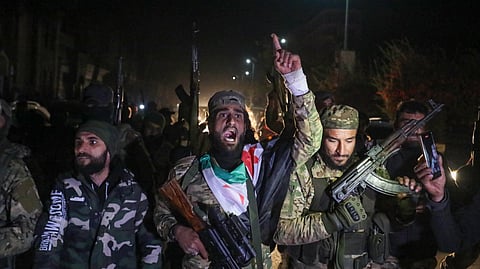  Islamist-led Syrian rebel fighters celebrate in the streets of Homs in the early hours of December 8, 2024, after entering Syria's third city overnight.