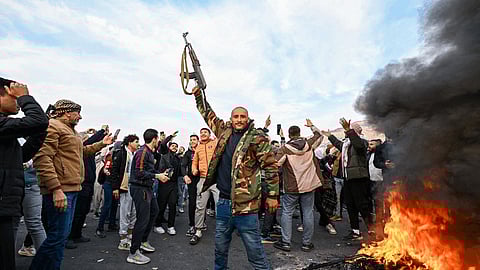 People celebrate in the cities of Damascus and Homs on December 8, 2024, after Islamist-led rebels declared that they have taken the Syrian capital, sending President Bashar al-Assad fleeing and ending five decades of Baath rule.