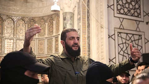 The leader of Syria's Islamist Hayat Tahrir al-Sham (HTS) group that headed a lightning rebel offensive snatching Damascus from government control, Abu Mohammed al-Jolani, addresses a crowd at the capital's landmark Umayyad Mosque on December 8, 2024.