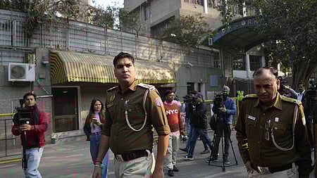Police personnel outside DPS RK Puram during an investigation after the school received a bomb threat, in New Delhi.