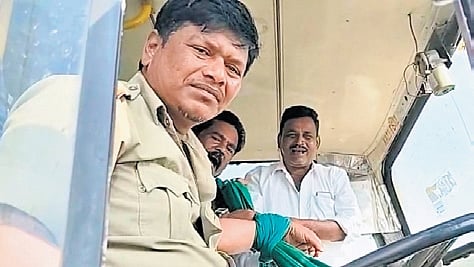 Farmers tie up the hand of a KSRTC bus driver, in protest against being prevented from staging an agitation near Suvarna Soudha on Monday
