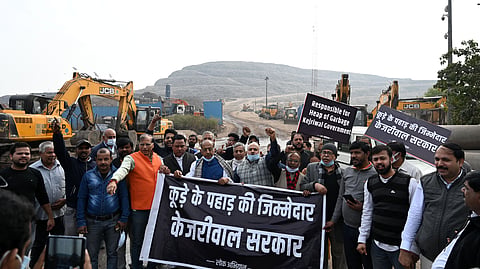 BJP leader Vijay Goel with party leaders and workers raise slogans during a protest against the AAP-led Delhi government near Ghazipur landfill site, in New Delhi on Sunday. 
