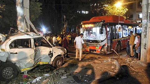 People gather near the wreckage of vehicles after a Brihanmumbai Electric Supply and Transport (BEST) undertaking's bus rammed into pedestrians as well as vehicles on a road at Kurla, in Mumbai, Monday, Dec. 9, 2024.