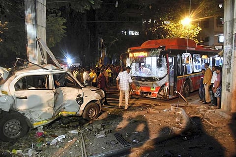 People gather near the wreckage of vehicles after a Brihanmumbai Electric Supply and Transport (BEST) undertaking's bus rammed into pedestrians as well as vehicles on a road at Kurla, in Mumbai, Monday, Dec. 9, 2024.