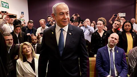 Israeli Prime Minister Benjamin Netanyahu, center, arrives to attend a hearing at the district court for his long-running trial for alleged corruption, in Tel Aviv, Israel, Tuesday, Dec. 10, 2024. 
