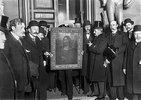 People gather around the Mona Lisa painting on January 4, 1914 in Paris France, after it was stolen from the museum du Louvre.